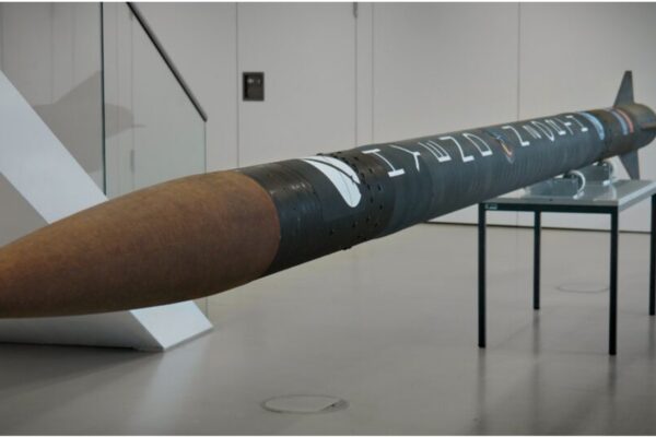 the N2ORTH rocket displayed indoors, laying horizontally on a table