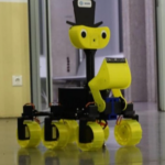 a rover in black and bright yellow with a smiling face painted on, driving inside