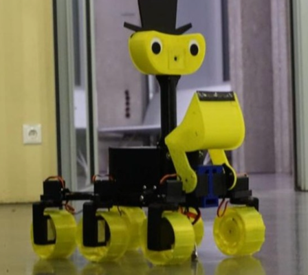 a rover in black and bright yellow with a smiling face painted on, driving inside