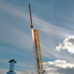 a rocket being launched in bright daylight