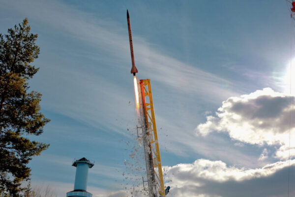 a rocket being launched in bright daylight