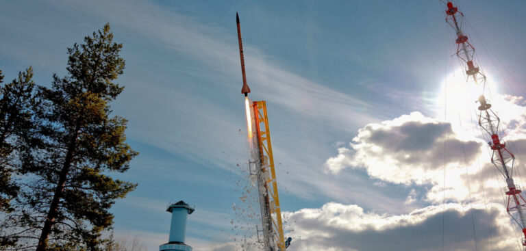 a rocket being launched in bright daylight